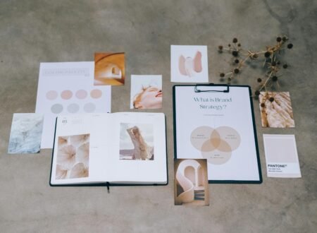 A flat lay of branding elements with color palettes and strategic planning documents on a concrete surface.